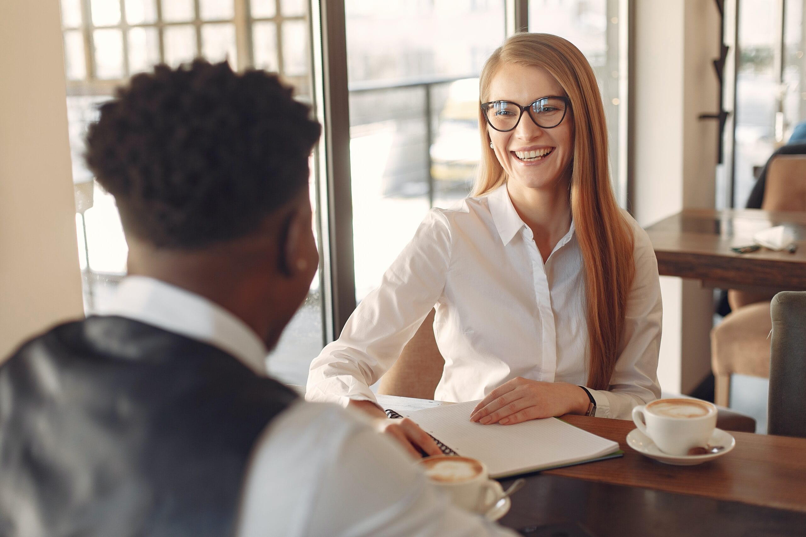 Woman interviewing man in a bright office space