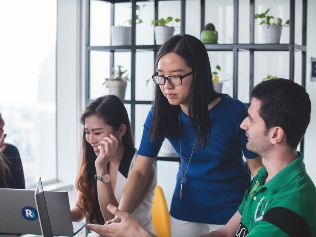 Man showing a chart on a monitor to a woman