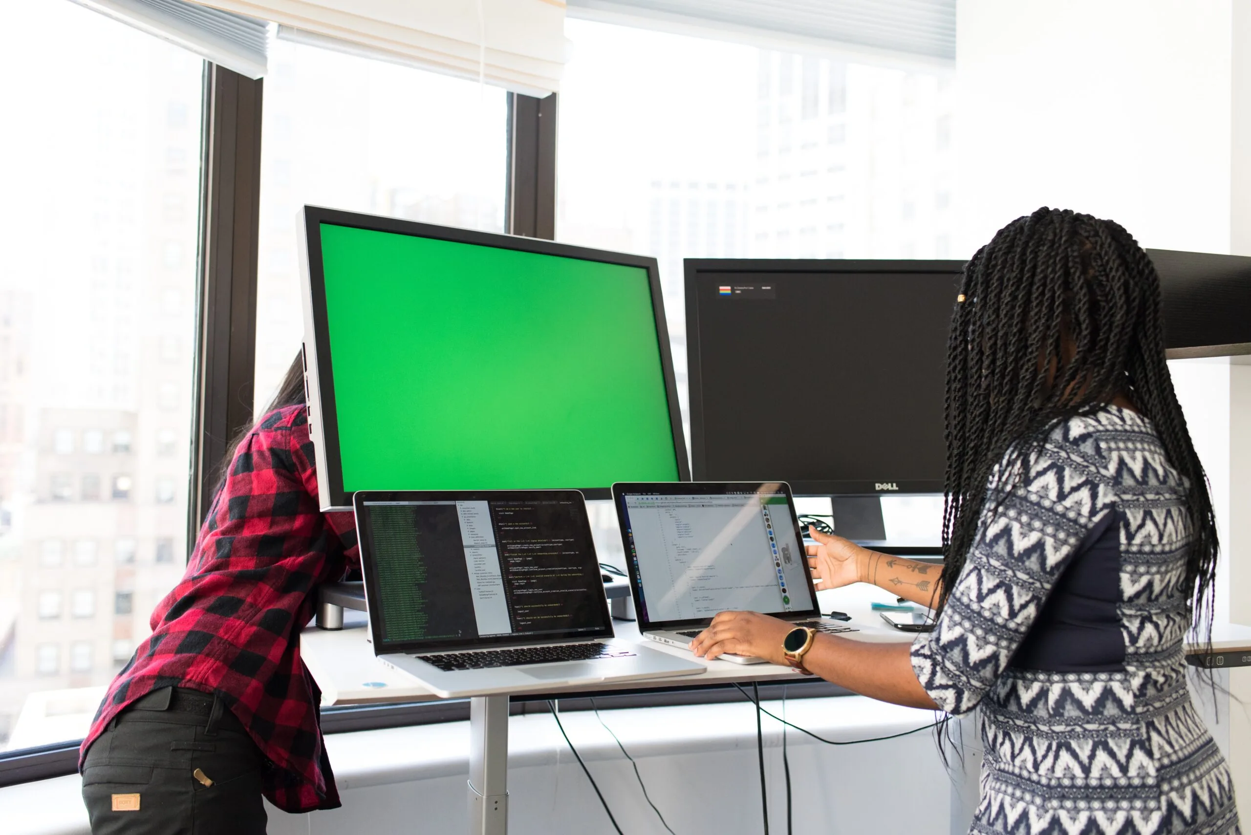 Woman standing in front of a computer screen