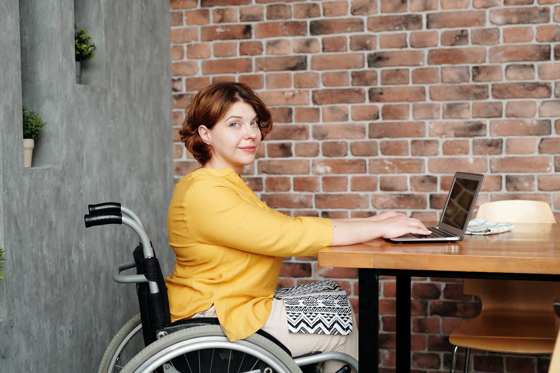 Woman in Yellow Long Sleeve Shirt Sitting on Black Wheelchair