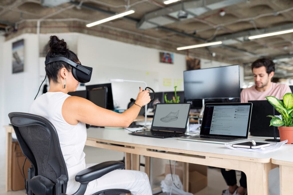 Person designing a shoe using a Virtual Reality headset