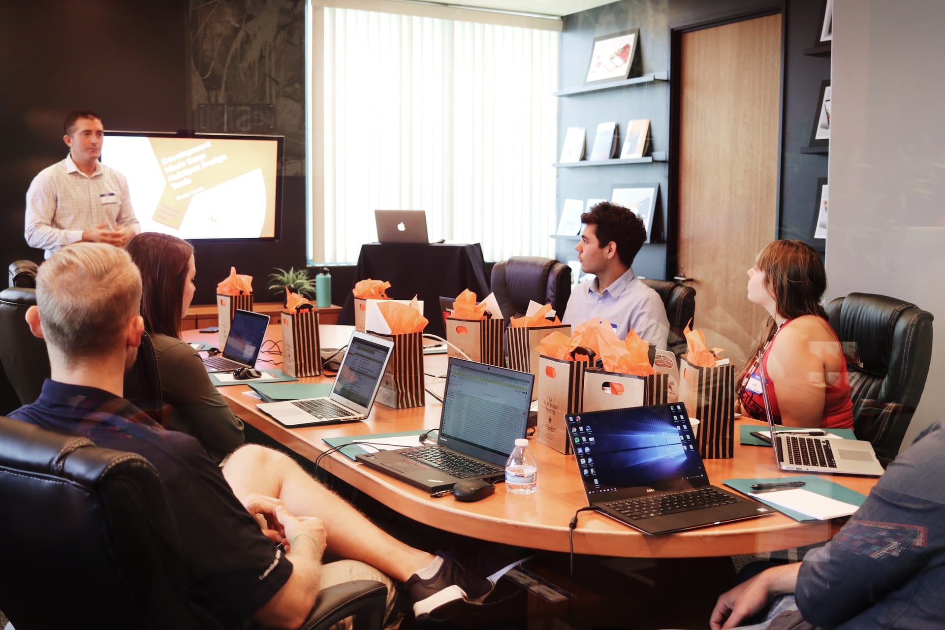 Man presenting to team in conference room