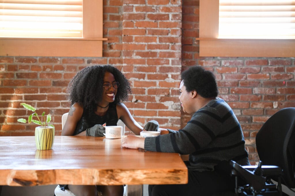Woman smiling talking to a person on a wheelchair