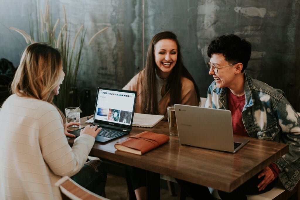3 people laughing in a table