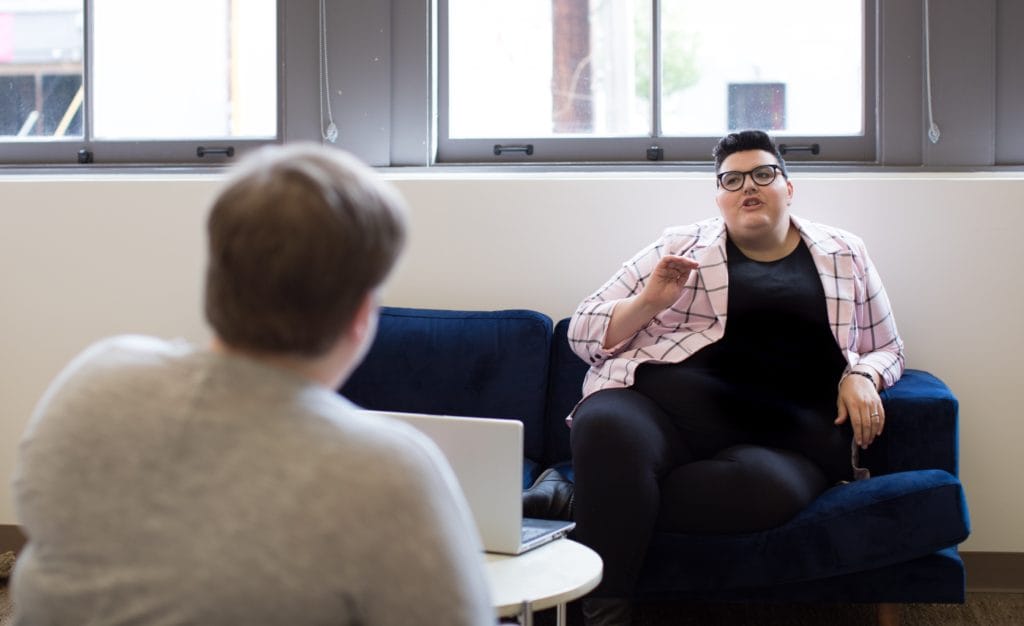 Two people at work in bright, open office workplace