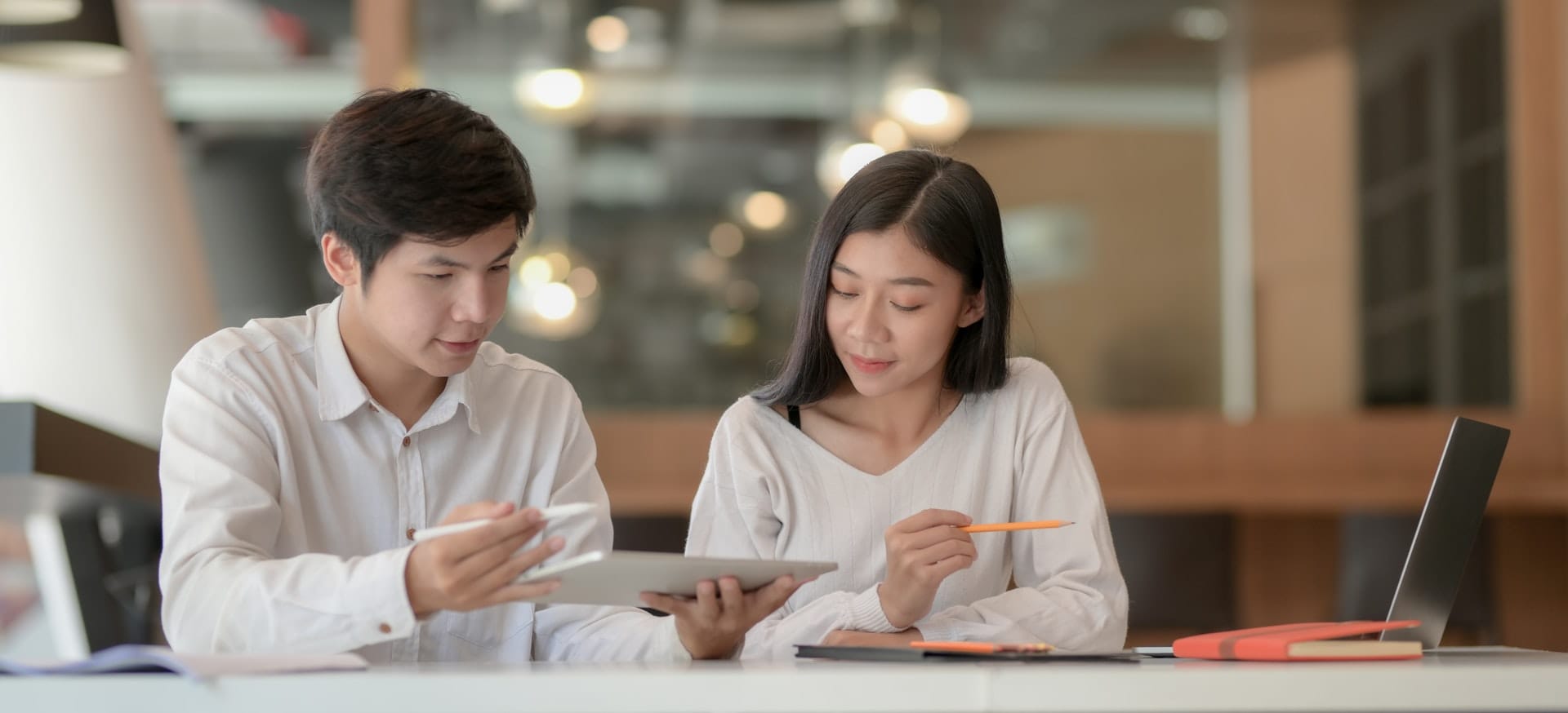 Man and woman reviewing business plan document