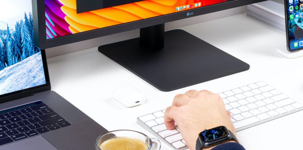 Person writing in the computer using a bluetooth keyboard