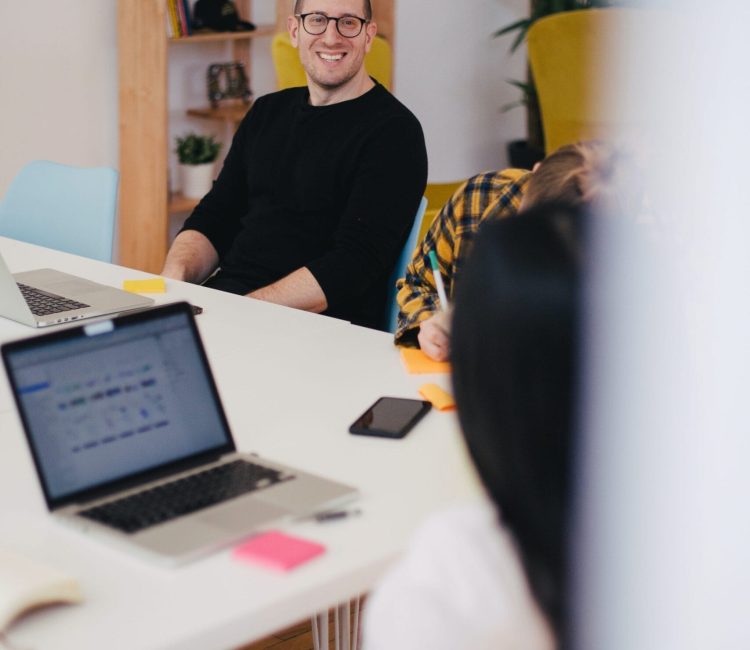 Man sitting and smiling at work meeting